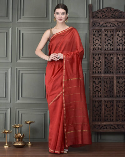 A timeless Red Chanderi silk saree, gracefully accented with delicate zari lines. Perfectly suited for understated festive occasions and refined formal gatherings