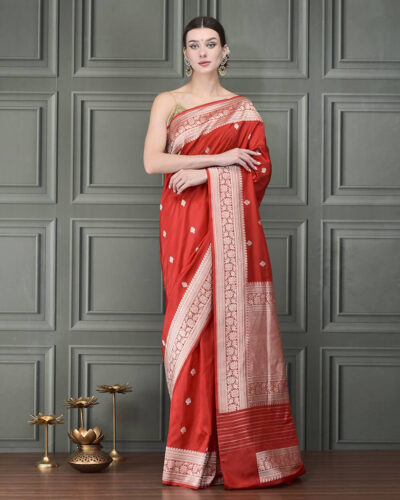 A handloom Katan Banarasi saree in graceful bail booti, framed by rich gold zari borders — heritage beauty, effortlessly regal